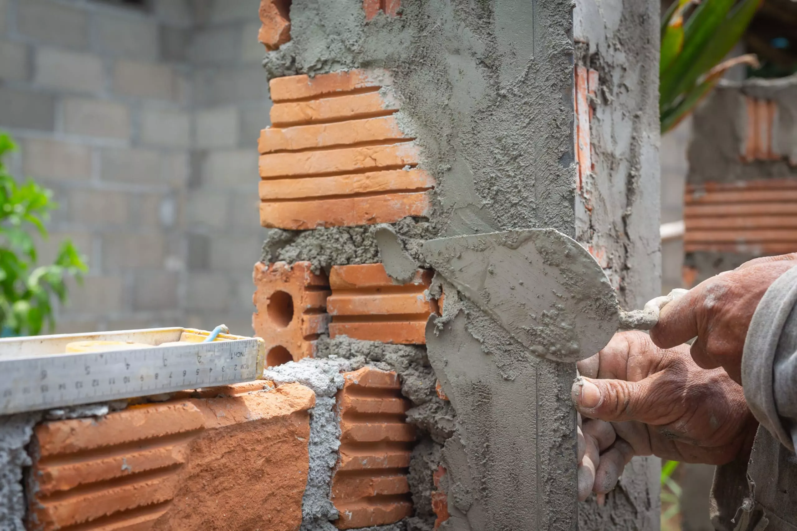 AnyConv.com__bricklaying-construction-worker-building-brick-wall-scaled