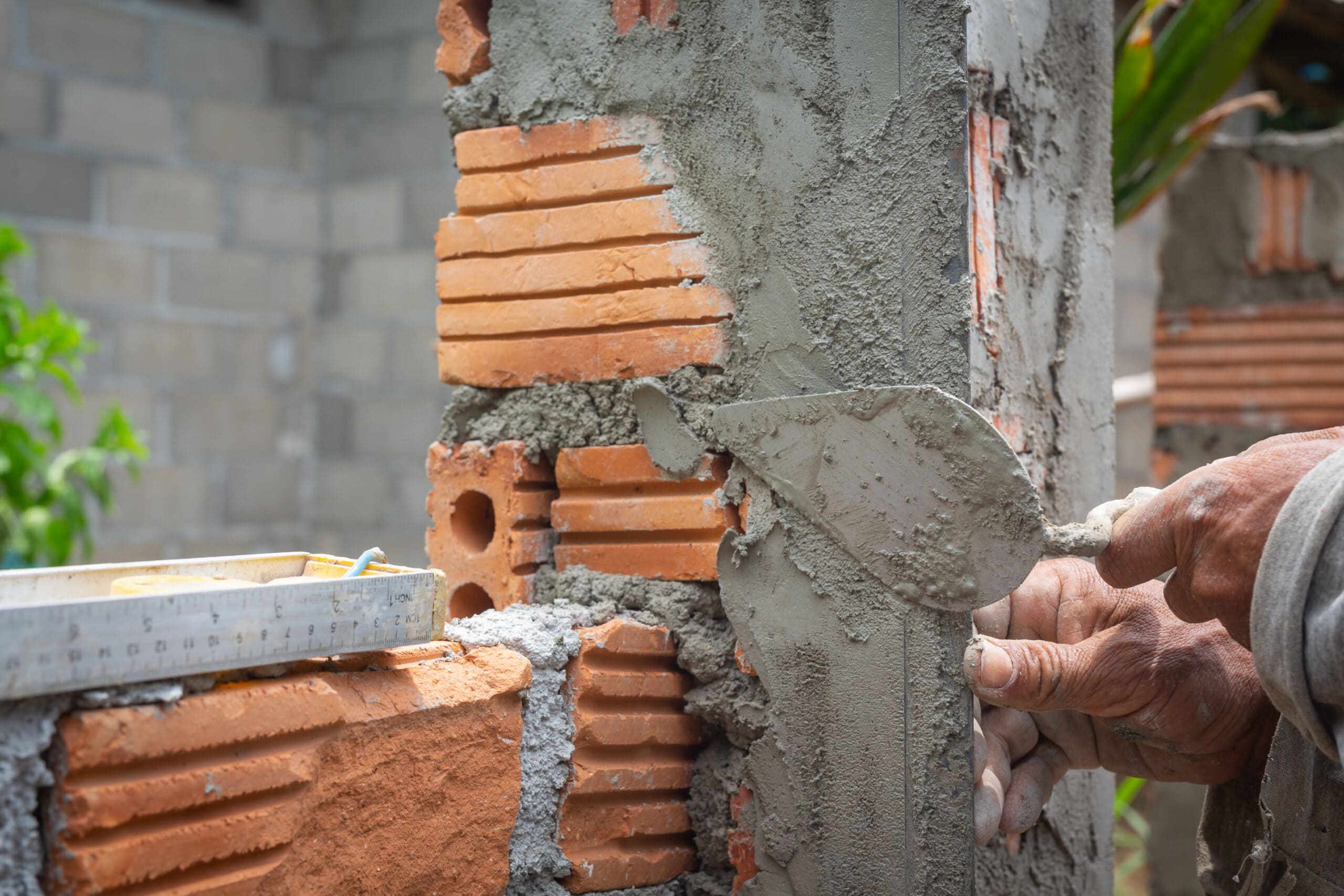 bricklaying-construction-worker-building-brick-wall-scaled